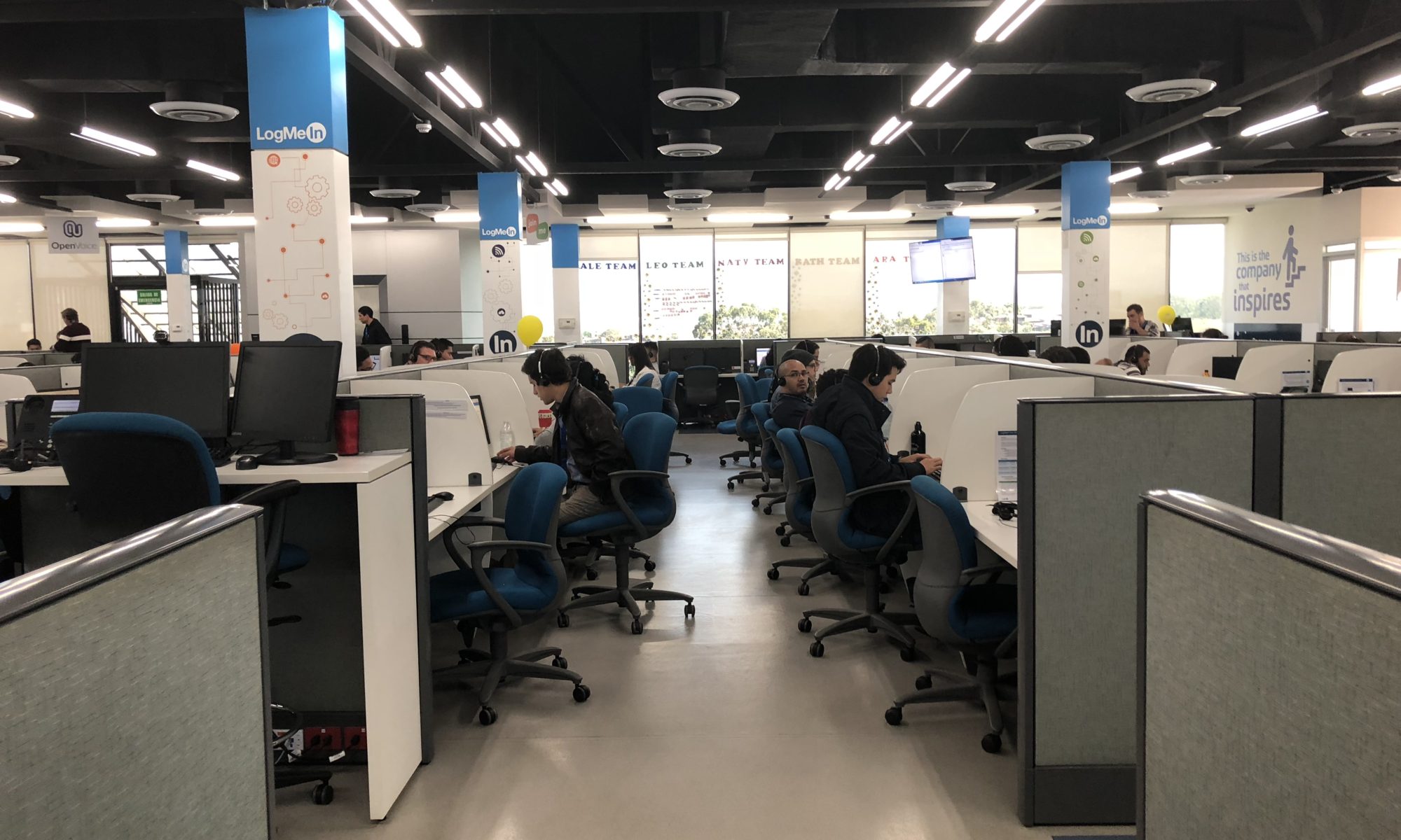 Image of a telephone support office with rows of desks