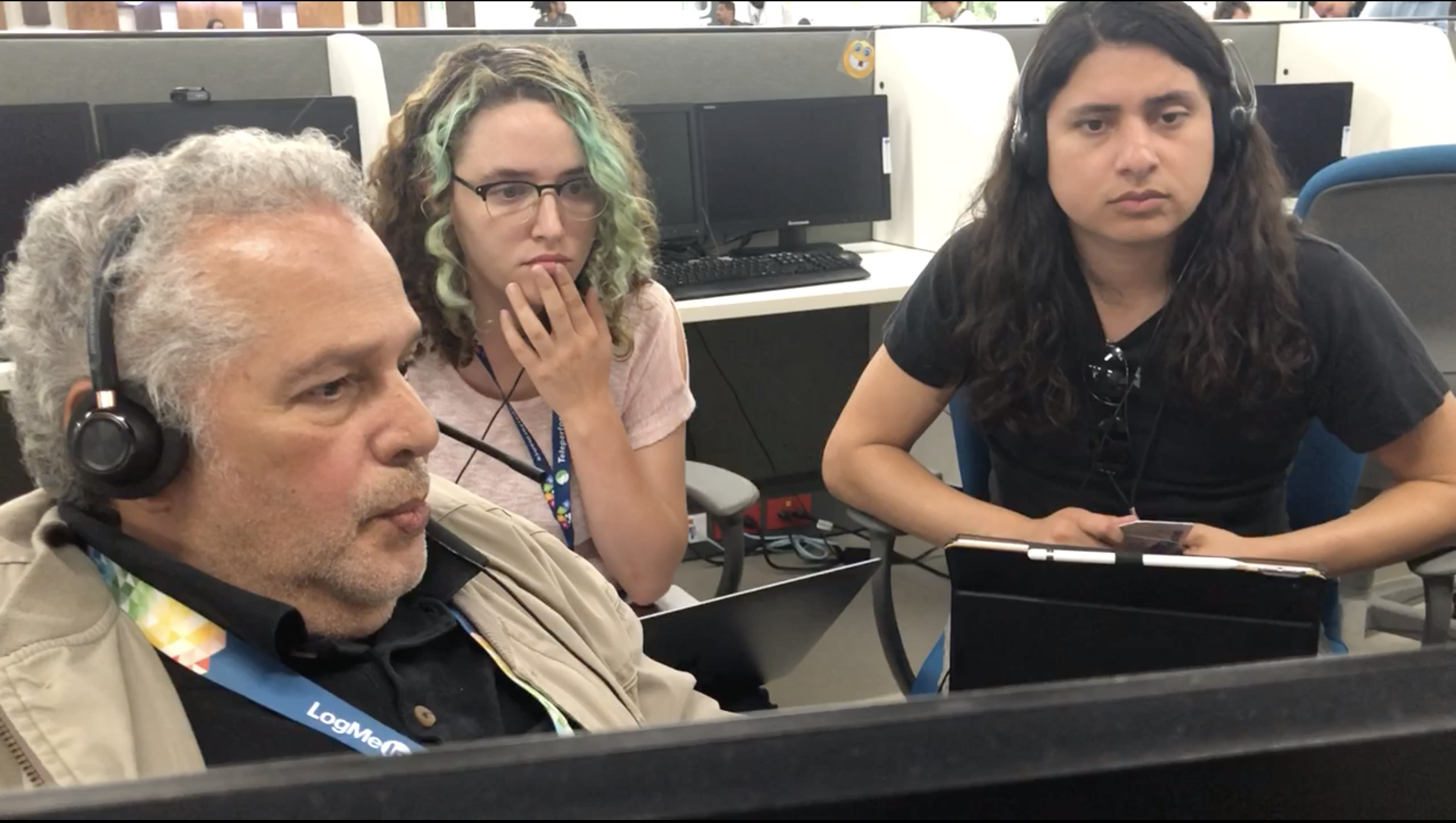 Image of two researchers Jessica Swartz and Rene Zelaya shadowing an agent as they take a call.